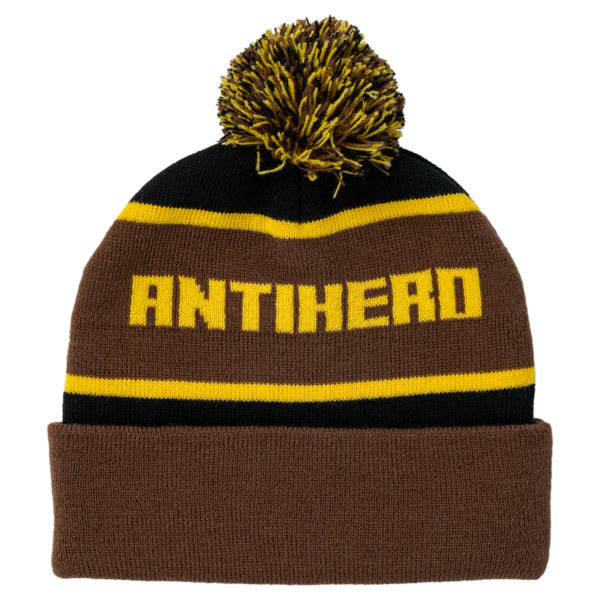 Brown and black beanie with yellow pom-pom and 'ANTIHERO' text on a white background